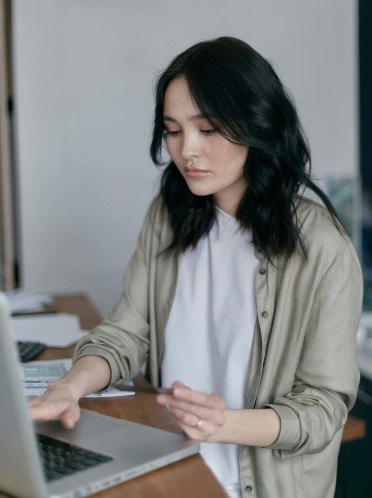 A financial expert reviewing tax-saving strategies with a calculator and tax documents.